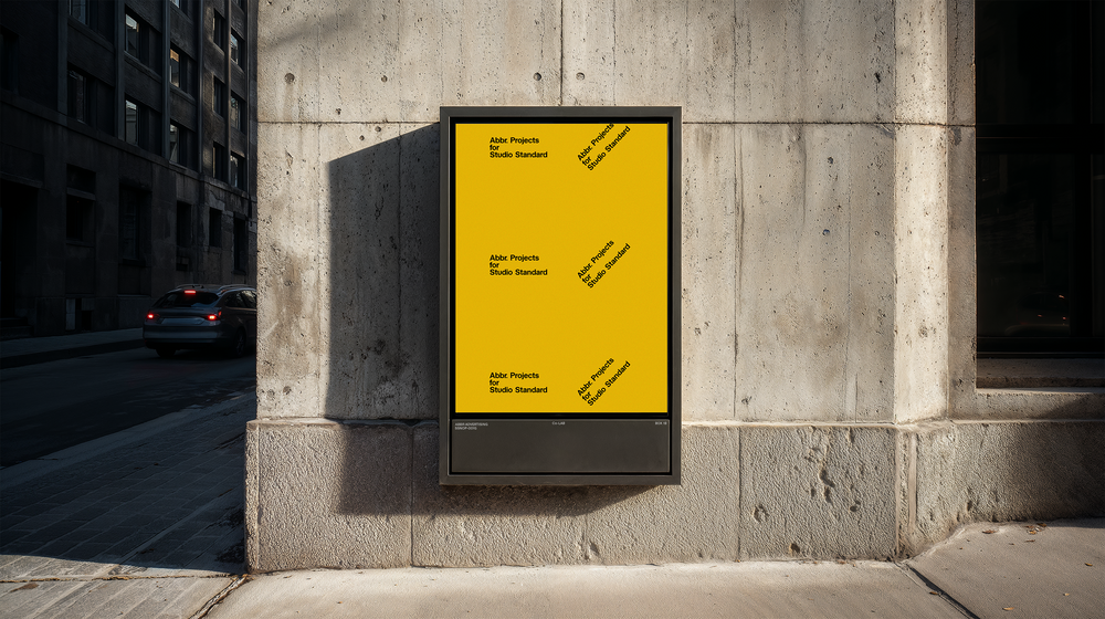 Street-level poster mockup displayed in a sidewalk lightbox on a concrete wall in an urban setting