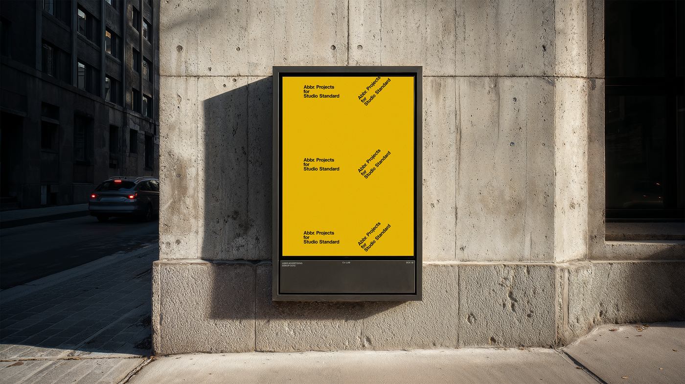 Street-level poster mockup displayed in a sidewalk lightbox on a concrete wall in an urban setting