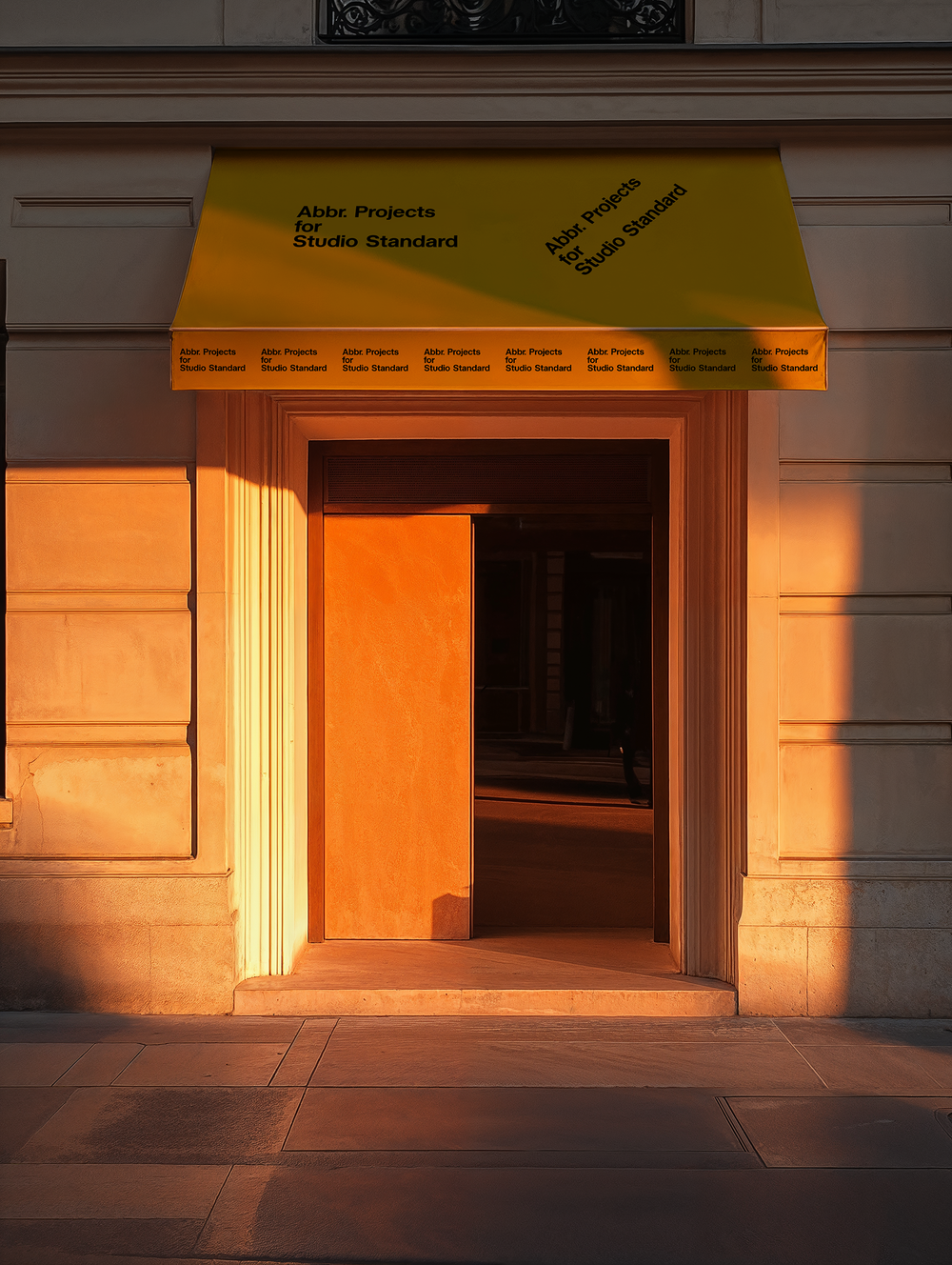 Storefront branding mockup with yellow awning over a Parisian-style entrance bathed in golden light