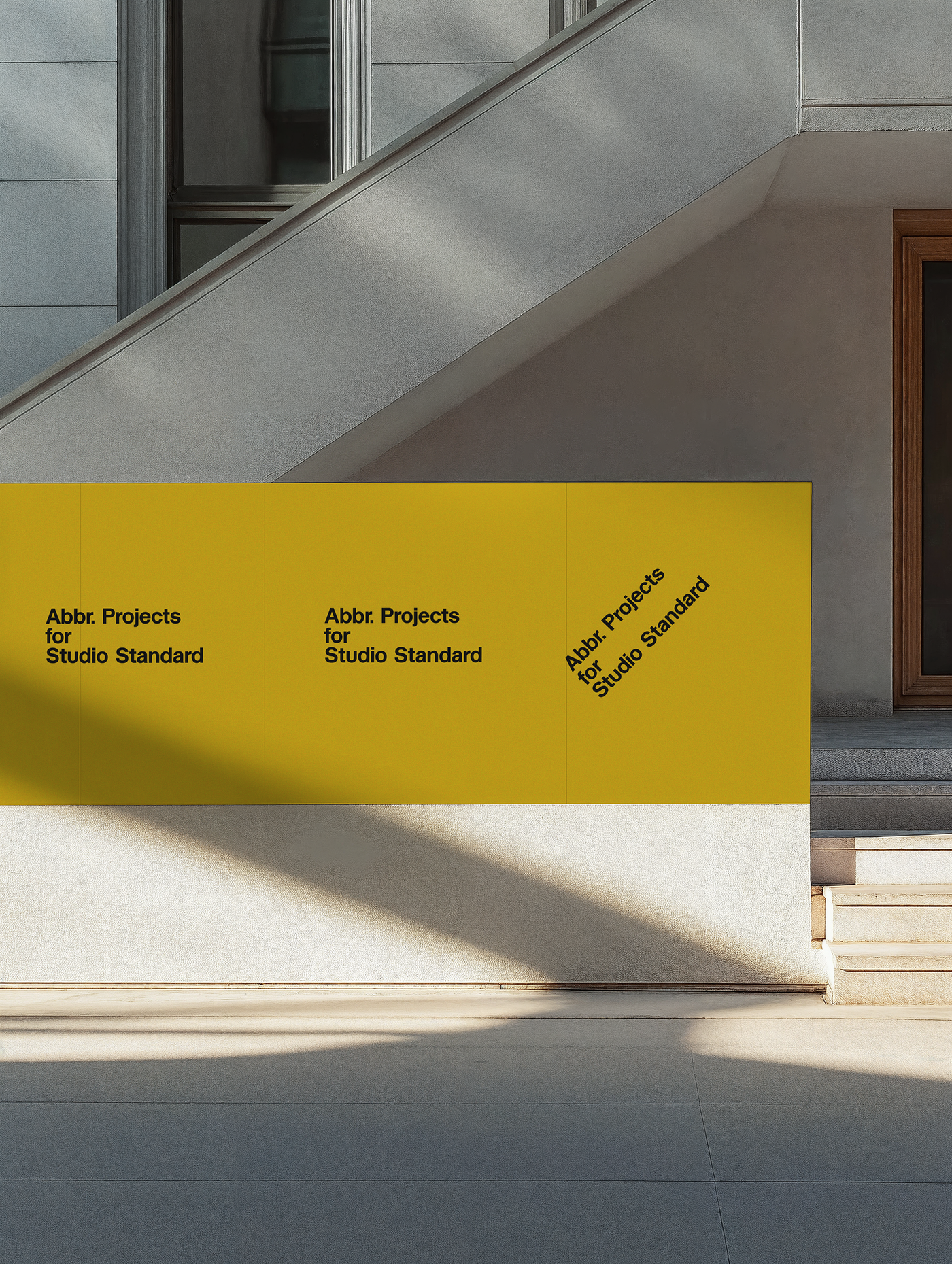 Branding mockup with yellow banner signage on a white building facade with diagonal sunlight and shadows