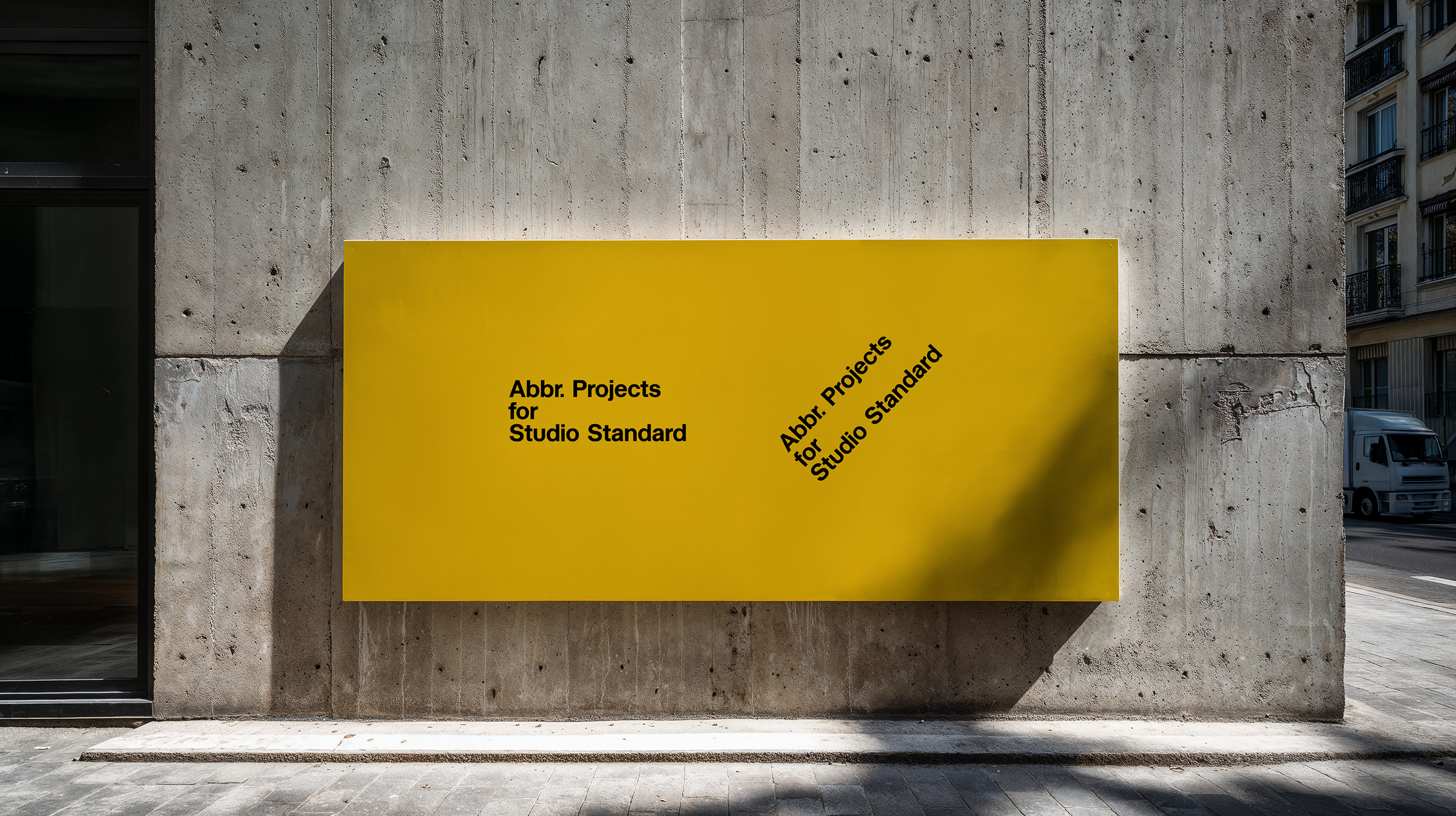 Poster mockup with yellow signage mounted on a brutalist concrete wall on a city sidewalk