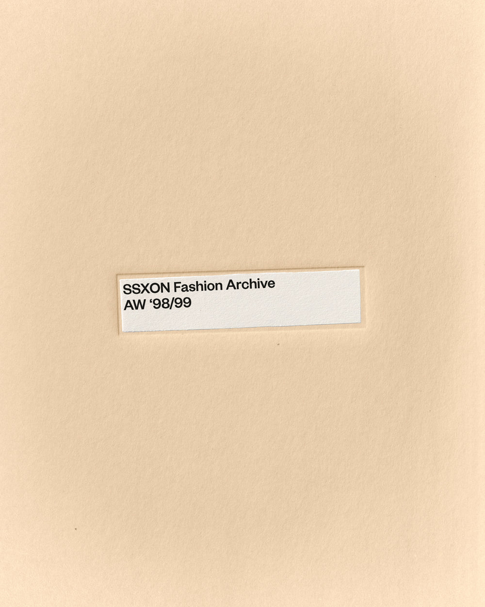 Minimal fashion archive mockup of a manila folder with centered label on warm paper texture by October November
