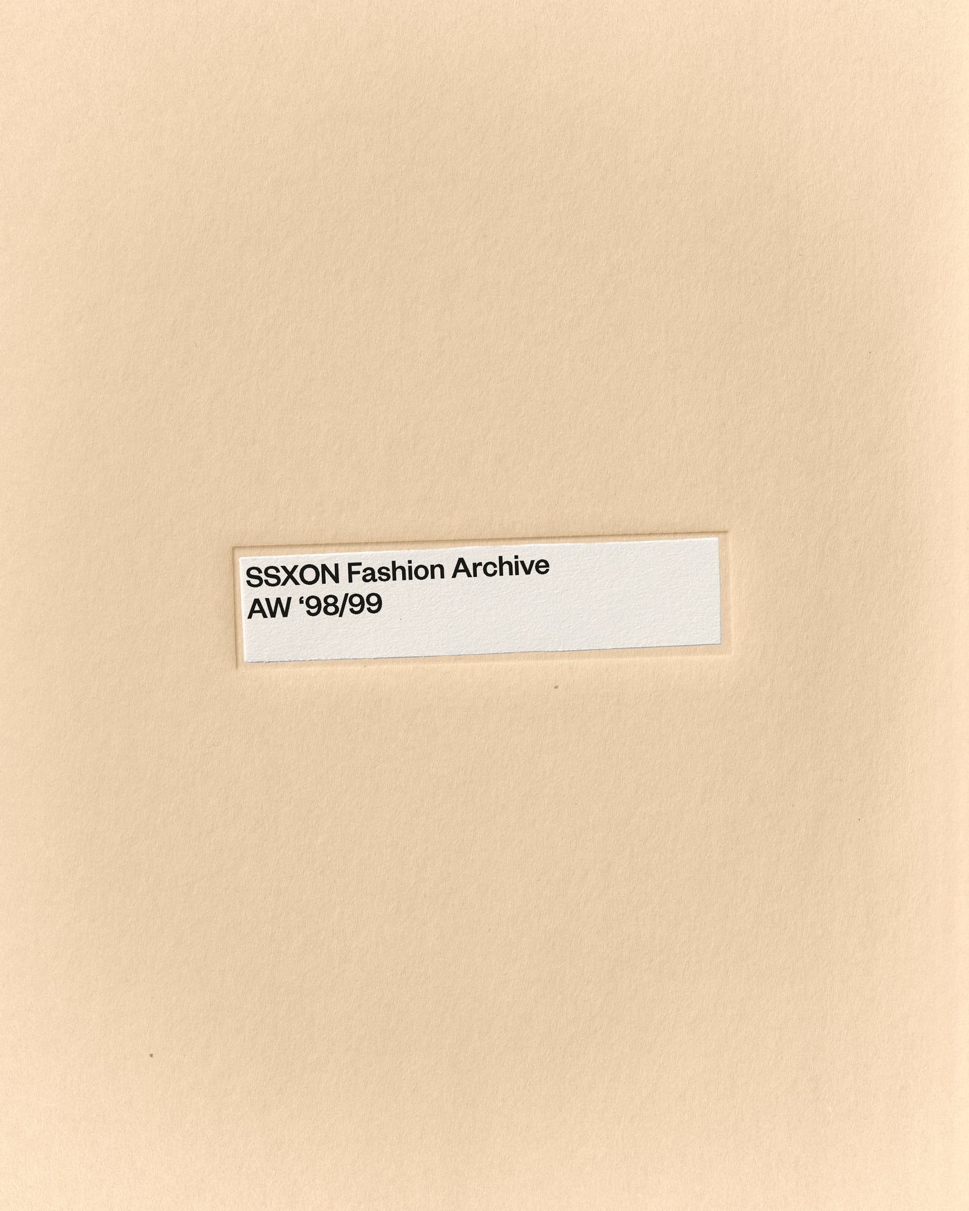 Minimal fashion archive mockup of a manila folder with centered label on warm paper texture by October November
