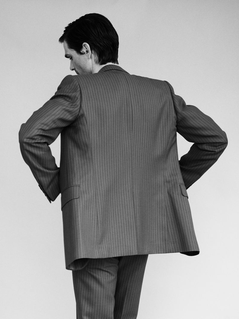 Pinstripe suit photographed from behind in black and white, art direction by Lisa Fessl